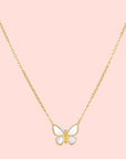 The Renewed Hope Pearl Butterfly Necklace features a gold chain and a delicate butterfly pendant with white enamel wings, crafted in 18k gold plated metal, displayed on a plain white background.