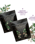 Two black packets of Teasoning Bundle—Matcha Salt and Lapsang Souchong Salt—feature botanical illustrations in the background, with stars and text showcasing each unique flavor.