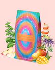 A vibrant bag of "333: Mango-Lemon Balm-Rose Herbal Tea with Passionflower" rests among apple, mango, passionflower, orange peel, and herbs—a pink elixir inspired by divine creativity—set on a pale pink background.