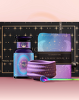 The Angel Numerology Fruit & Flower Tea Gift Set includes a black and gold box, a blue and purple "444 Angel" tea jar, a matching tea towel, purple ceramic bowl, and decorative spoon, elegantly displayed on a pink background.