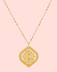 18” White topaz lotus medallion necklace featuring a decorative lotus-shaped pendant with intricate detailing and embedded white topaz stones, hanging from a delicate gold chain.