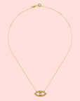 The Eye Blue Topaz Necklace is a gold-plated piece with an eye-shaped pendant, outlined with small clear stones and a larger blue topaz at the center, shown on a plain white background.