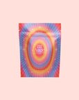A vibrant pouch labeled “777: Celestial Messengers Dawn,” decorated with starburst and star designs, features uplifting phrases to inspire spiritual awareness on a light pink background.
