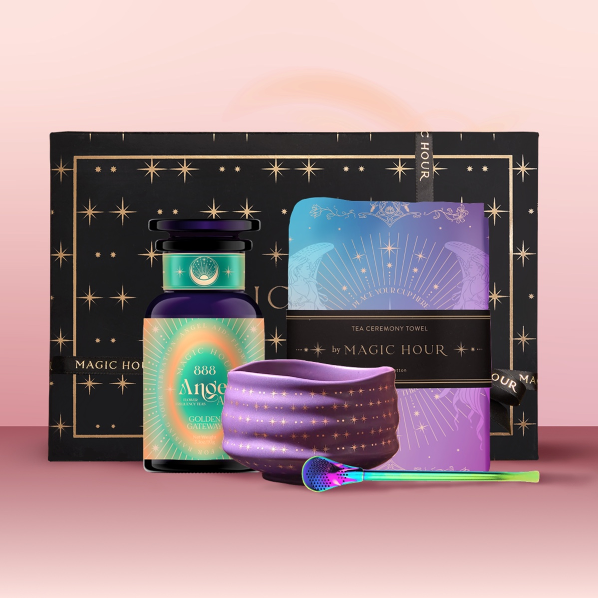 The Angel Numerology Fruit & Flower Tea Gift Set features a bottle labeled "888 Angels," a star-patterned cloth, a multicolored tea scoop, and a decorative booklet—all with mystical pastel designs on a pink background.