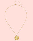The 18" Sunburst Medallion Necklace is a gold plated piece featuring a round celestial-inspired pendant, perfect for adding charm to your look.
