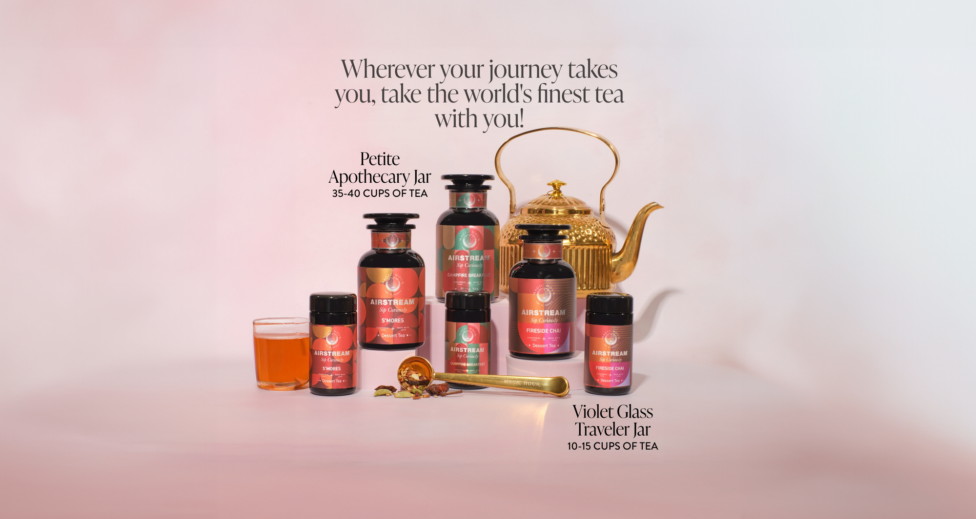 A promotional setup for tea products featuring several jars labeled with tea blends, a cup of tea, a golden teapot, and text that reads, "Wherever your journey takes you, take the world's finest tea with you! Petite Apothecary Jar 35-40 Cups of Tea, Violet Glass Traveler Jar 10-15 Cups of Tea.