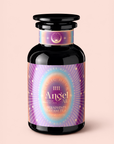 A black glass bottle with a vibrant, mystical label reading “111: Lavender-Jasmine-Pineapple Herbal Tea with Blue Lotus,” adorned with stars, rays, and pastel gradients on a light pink background. Infused with enchanting ingredients like lavender, jasmine, pineapple, and Egyptian blue lotus, this blue elixir invites you into a realm of dreamy tranquility.