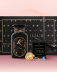 The Aries Astrology Tea Gift Set features a black and gold "Magic Hour" box, a matching astrological tea jar, gold tea infuser, and Opal Moon Ritual Tea blend with botanical packaging on a pink gradient background.