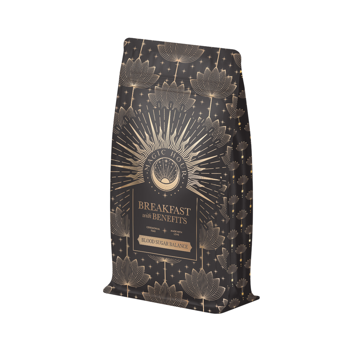 The "Breakfast with Benefits: Blood Sugar Balance" coffee bag boasts golden lotus flowers and star patterns on a dark background. Infused with Assam tea notes, it aims to make mornings magical while supporting blood sugar balance.