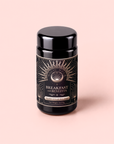 A black jar labeled “Blood Sugar Balance: Breakfast with Benefits” stands on a light pink background. Its label features a stylized sunburst and celestial design with gold accents, evoking the nourishing blend within—crafted with Gymnema Sylvestre and Assam Black Tea for an energizing start to your day.