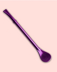 The Beauty Inside & Out Box features a metallic purple bombilla with a flat mouthpiece and perforated spoon filter, perfect for yerba mate or tea ceremonies, showcased on a light pink background.
