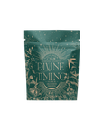A green tea package with gold illustrations of plants, stars, and a bird. The label reads "Divine Timing Calm," a personalized wellness tea with adaptogens for hormonal balance—teas for the ancient's priestess.
