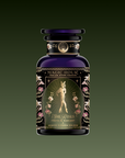 A decorative dark glass tea jar labeled "Freya: The Radiant." The label shows an elegant glowing woman amid flowers with ornate gold designs.