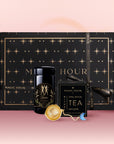 The Gemini Astrology Tea Gift Set features a black box with gold stars labeled "Magic Hour," containing a tea jar, infuser, and small tea box—perfectly displayed on pink with a gradient background.