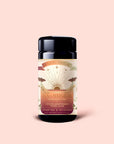 A cylindrical tin labeled "Tea for Adventure: Horchata Chai: Spiced Yerba Mate," featuring a sunrise design inspired by Tulum, contains adaptogen yerba mate horchata chai tea sachets with ashwagandha, and is displayed against a pale pink background.