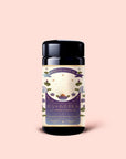 A black tea canister labeled "Tea for Intuition: 1111: Pineapple & Butterfly Pea Flower Herbal Tea" with a mystical, celestial-themed design featuring crystals, blue lotus, butterflies, and plants on a pale background—perfect for crown chakra alignment.