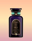 A dark purple bottle labeled "Magic Hour" with gold and turquoise accents features an hourglass illustration. The label reads "Time for Infinity" and "Mantra Mint™ Herbal Tea," a caffeine-free blend with soothing Ashwagandha.