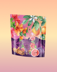 Pink Moment Pixie - Hibiscus Tangerine Dream Herbal Tea comes in a colorful, resealable pouch with hibiscus flowers, oranges, figs, cinnamon sticks, and more on a pink-purple background—perfect for this immune-supporting blend.