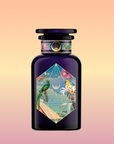 A dark purple Tulum Horchata Chai perfume bottle with an illustrated label featuring a parrot, two people, palm trees, and pyramids amid vibrant geometric designs sits against a soft peach-to-pink gradient background.
