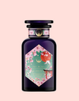 Queen of Kyoto: A dark purple perfume bottle with a hexagonal label featuring cherry blossoms, a white bird, and red and white balloons, inspired by Japan's Cherry Blossom Festival, set on a pastel pink background.
