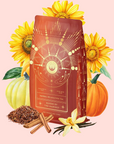 A red package of Queen of the Harvest: Herbal Relaxation Tea sits on a light pink background, surrounded by sunflowers, a white pumpkin, an orange pumpkin, loose tea leaves, cinnamon sticks, and a vanilla flower.