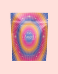 A vibrant tea pouch labeled "555: Celestial Harmony: Papaya-Mango-Rose Tea with Ashwagandha" features starburst patterns in pink, blue, yellow, and purple gradients, suggesting a stress-relief herbal blend on a light pink background.
