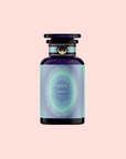 A blue and purple gradient glass bottle labeled "999: Adaptogenic Pineapple-Mint-Jasmine Herbal Tea," with gold accents and a round black cap, inspired by celestial blue blend, set against a light pink background.