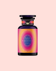 A vibrant perfume bottle with a purple-pink gradient label reading "555: Celestial Harmony: Papaya-Mango-Rose Tea with Ashwagandha" stands against a light pink background, featuring a black cap and gold accents, inspired by ashwagandha for stress relief.