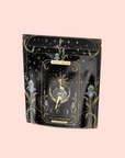 A black pouch with gold and pastel blue tarot artwork labeled "The High Priestess" showcases a mystical woman, flowers, and stars, promising caffeine free herbal tea: Ginger-Mint-Cardamom Tea for Powerful Dreams & Illuminated Insights.