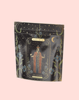 A decorative black and gold tea package labeled "Magic Hour," featuring "The Emperor" tarot card art with ornate floral and celestial designs on pale pink, showcases The Emperor: Green Chaga Chai with Lion's Mane and Reishi for immune support.