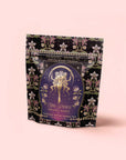 A floral tea package labeled “Monthly Magic Tea Journey Subscription” with an illustrated goddess—perfect for ritual tea—set against a pale pink background.