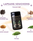 A jar of Lapsang Souchong Season Salt sits at the center, surrounded by images and labels of its ingredients: Lapsang Souchong tea, mushroom seasoning, brown sugar, rosemary, and thyme.