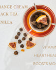 A glass of tea with an infuser containing a dried orange slice and tea balls. Surrounding the glass are additional tea balls and orange slices. Text on image reads: "ORANGE CREAM, BLACK TEA, VANILLA" and "VITAMIN C, HEART HEALTH, BOOSTS MOOD." Experience the magic of Leo: Queen of Courage Tea of the Sun by Magic Hour.