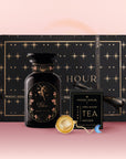 The Libra Astrology Tea Gift Set includes a black Libra-themed tea jar, Opal Moon Ritual Tea floral blend, a gold infuser, and a star-patterned black box with "Magic Hour" on a pink gradient background.