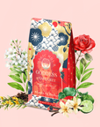 A vibrant London Fog Rooibos tea bag is surrounded by roses, white flowers, lime slices, and tea leaves on a pink background, capturing the essence of a floral herbal blend.