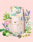 A decorated tea package labeled "London Fog White" is surrounded by flowers, bergamot fruit, lavender, and vanilla on a soft pink background. The packaging features peacocks and botanical illustrations.