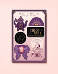 The Magic Hour Sticker Sheet: Time for Infinity features six mystical stickers with decorative designs and phrases in purple, black, and gold on a pale pink background—perfect for adding magical vibes to your collection.