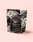 A pale pink package labeled "Goddess of Earl: Madagascar Vanilla Creme Tea for Soothing Delight & Delicious Decadence" features floral patterns and highlights a rich bergamot vanilla tea with ceremonial and loving details.