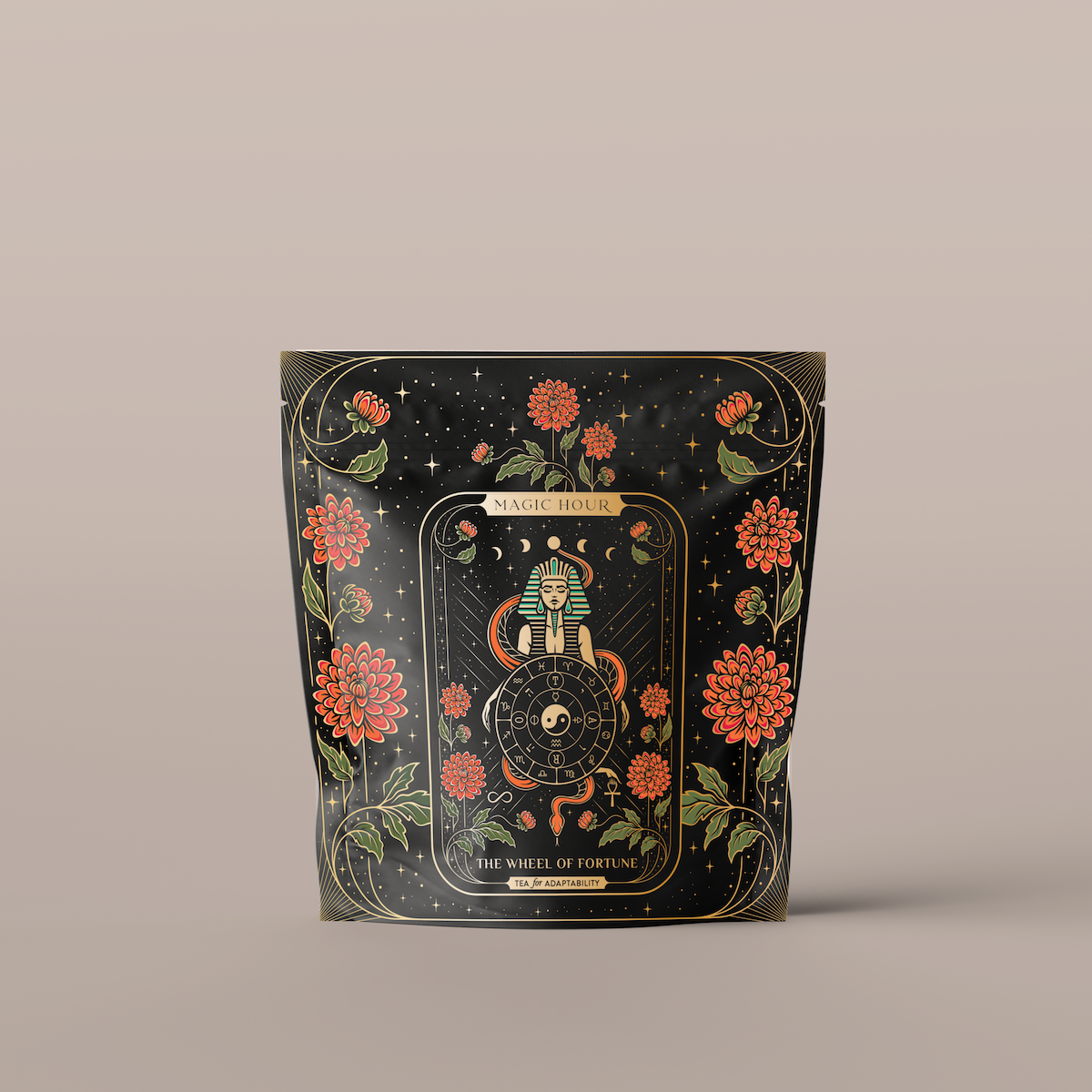 A black, resealable bag adorned with ornate, mystical gold and red designs. The center features a wheel with intricate symbols, flanked by two snakes and surrounded by vibrant red flowers and delicate gold leaves. Text at the top reads "The Wheel of Fortune".