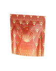 A decorative tea package labeled "Hydrate Tea Boost - Magic Hour" is shown. The packaging features a geometric, art-deco design with warm tones of red, orange, and gold, accented by cream and yellow. The front includes a starburst graphic along with the product details.