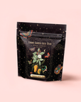 A black resealable bag labeled "Mango Jasmine Oolong Iced Tea" shows mangoes, jasmine flowers, butterflies, and stars on a soft pink background—enjoy this metabolism-boosting blend of mango oolong and jasmine green tea.