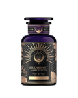A dark purple and gold jar labeled "Metabolism Balance: Breakfast with Benefits" features intricate sunburst patterns and celestial motifs. Elegantly crafted, it holds bold black tea infused with metabolism-boosting spices, providing an organic blend for a luxurious start.