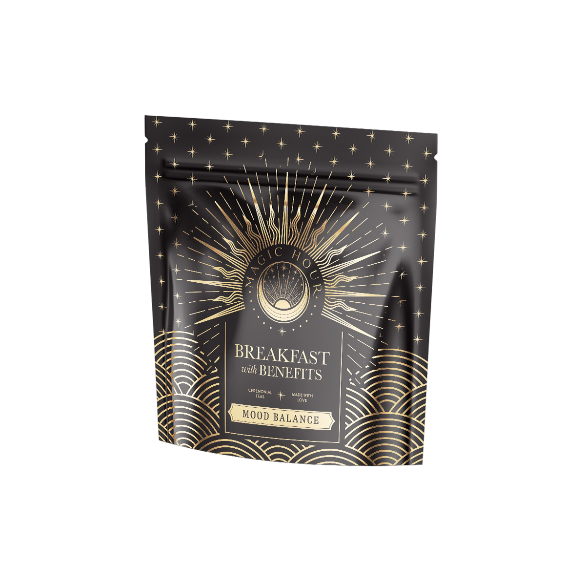 A black and gold patterned pouch labeled "Mood Balance: Breakfast with Benefits," adorned with starbursts and waves, promotes the calming effects of Ashwagandha root for a serene morning.