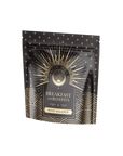 A black and gold patterned pouch labeled "Mood Balance: Breakfast with Benefits," adorned with starbursts and waves, promotes the calming effects of Ashwagandha root for a serene morning.