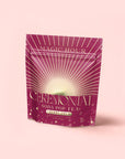 A magenta pouch labeled "Cherry Cola Black Tea: Ceremonial Soda Pop Tea" by Magic Hour features gold and white rays, bubbles, and a soft pink background—a delightful cherry cola tea with natural sweetener.