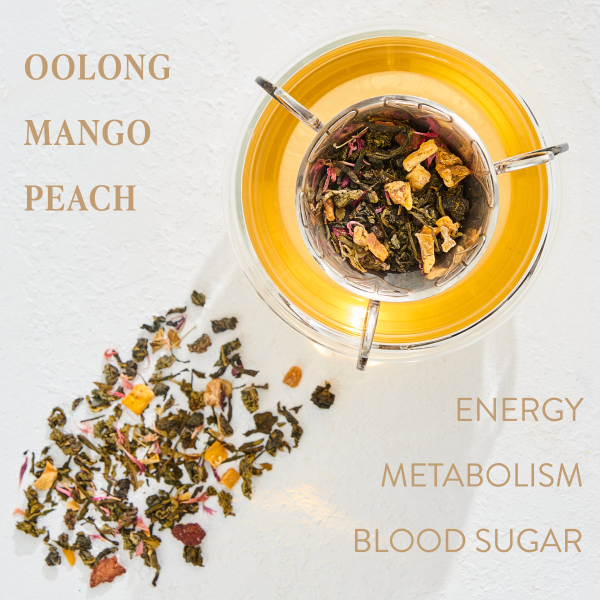 A clear cup of Peridot: Green Guayusa Oolong Mango-Peach Tea from Magic Hour sits on a white surface, with some tea ingredients scattered around it. The text around the image reads "OOLONG MANGO PEACH" and "ENERGY METABOLISM BLOOD SUGAR.