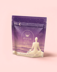 A purple and cream package labeled "Pitta: Caffeine-Free Saffron Tea for Balancing Body, Mind & Emotions" features a meditating silhouette, stars, and mountains, emphasizing calming balance with saffron tea and Ayurvedic herbs.