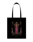 Queen of Cups Tote Bag: A beautifully illustrated tote bag showcasing a tarot card design with the Queen of Cups dressed in a red gown. The design features moons, stars above, and is adorned with floral motifs. It includes the text "The Queen of Cups" at the bottom.