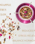 A glass cup filled with herbal tea sits on a white surface. Surrounding the cup are scattered tea leaves and petals. Text on the image highlights Magic Hour's Queen of Wellness: Women's Hormone Balancing Tea for PMS, Healthy Cycles & Menopause flavors: pineapple, citrus, melon, and its benefits: reduces PMS, stress-reliever, balances hormones. Enjoy this organic loose-leaf tea for a moment of tranquility.