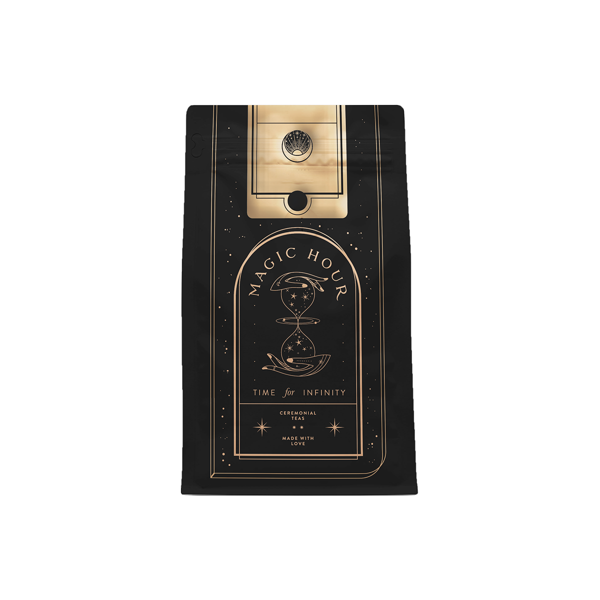 A person with dark blue nails holds a black box with white celestial designs and